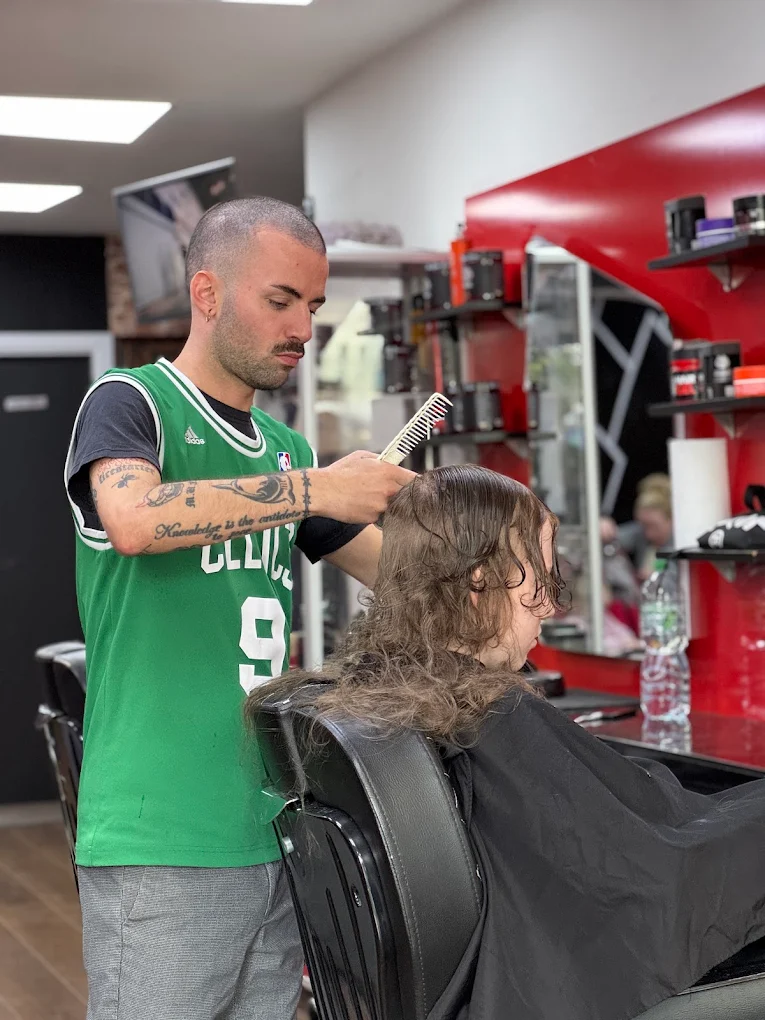 Barber sectioning hair with a comb